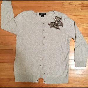 Soft grey cardigan with silver beaded bow.